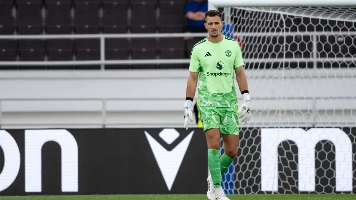 Goalkeeper in green kit standing in front of goal Goalkeeper in green kit standing in front of goal