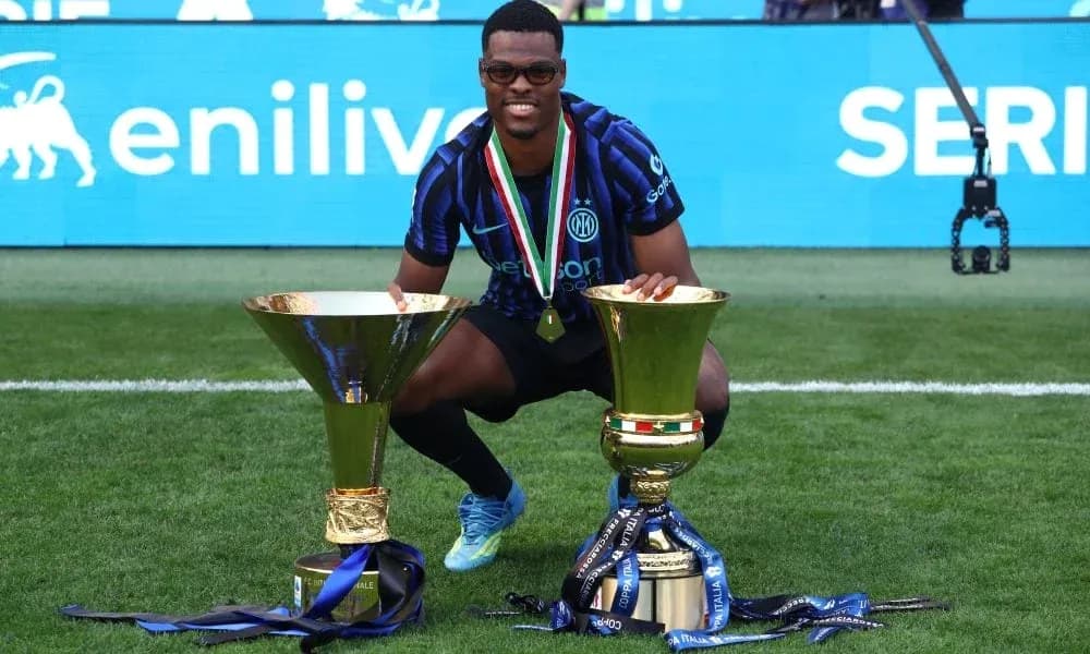 Player celebrating with two trophies after victory Player celebrating with two trophies after victory