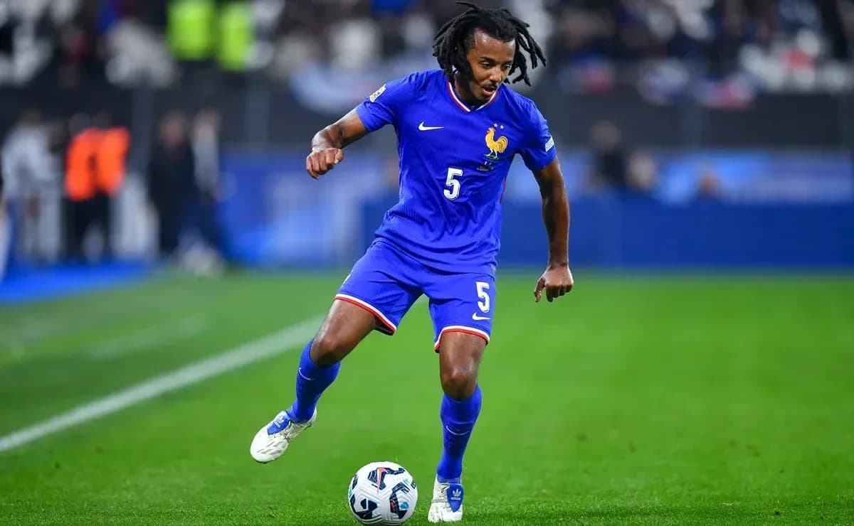 Player in blue jersey dribbling soccer ball on field Player in blue jersey dribbling soccer ball on field