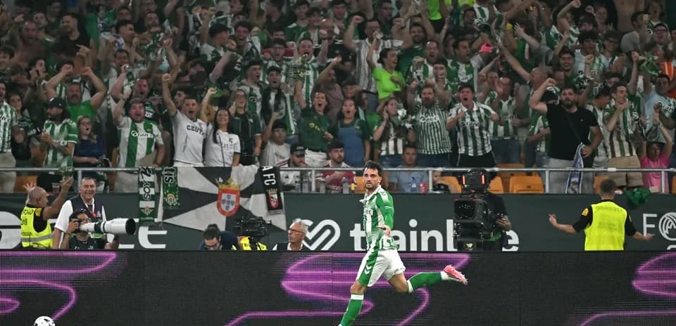 Player celebrating a goal with cheering fans behind Player celebrating a goal with cheering fans behind