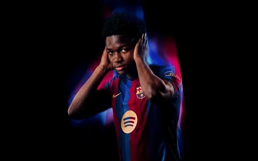 Player in Barcelona jersey posing with hands on ears Player in Barcelona jersey posing with hands on ears