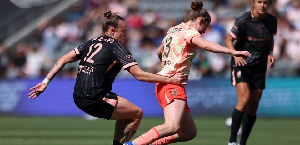 Players competing for the ball during NWSL match Players competing for the ball during NWSL match