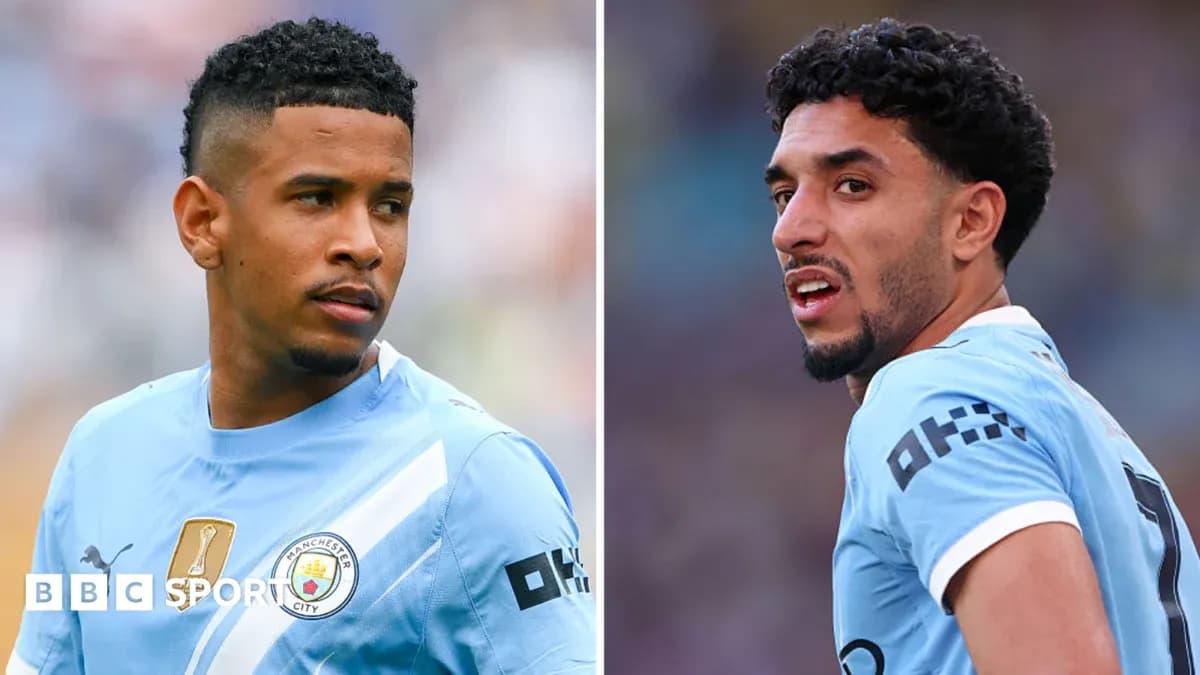 Two Manchester City players in light blue jerseys Two Manchester City players in light blue jerseys