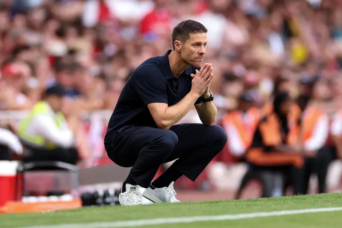 Coach observing the match while kneeling on sidelines Coach observing the match while kneeling on sidelines