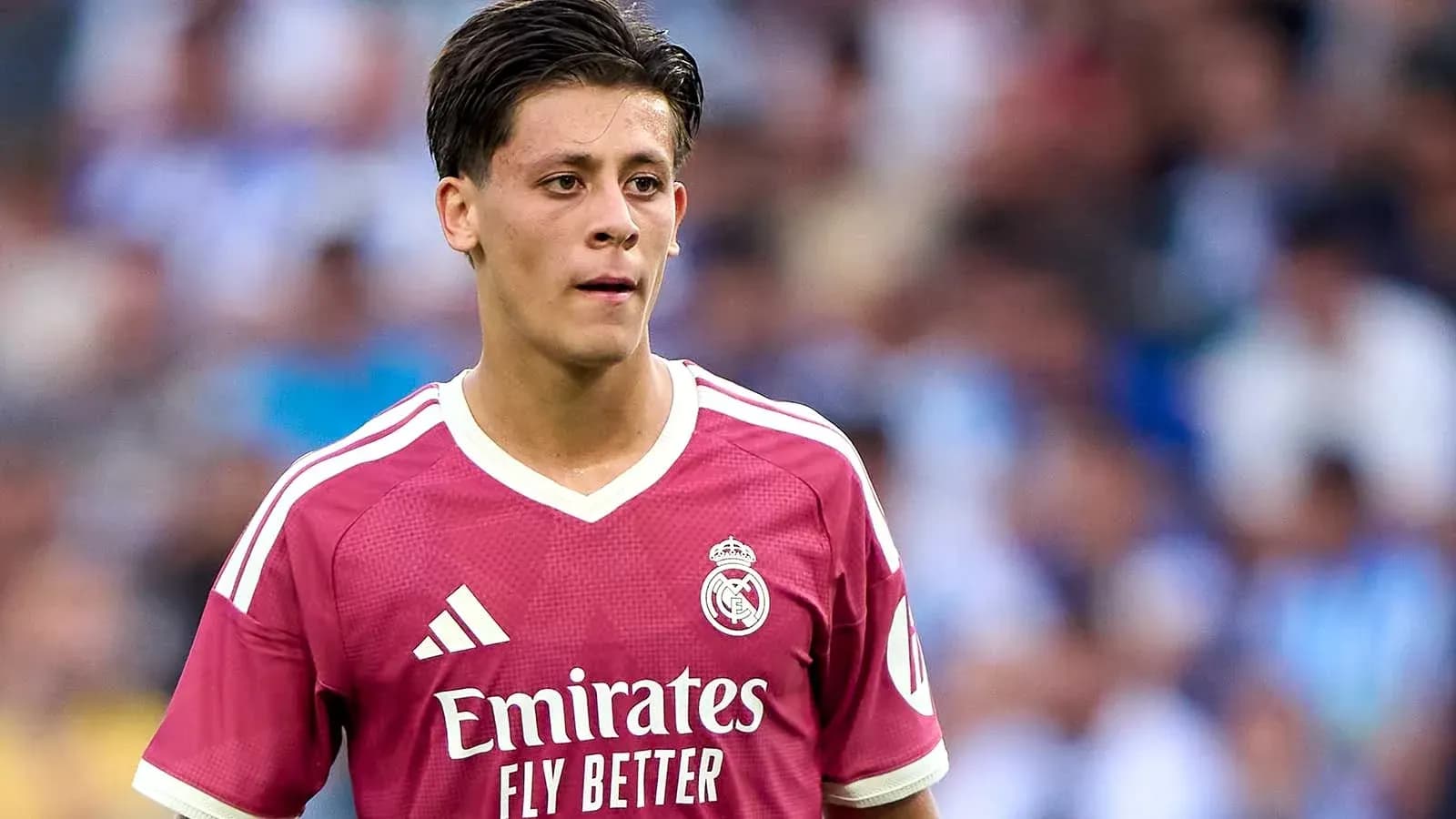 Player wearing pink Real Madrid jersey on field Player wearing pink Real Madrid jersey on field