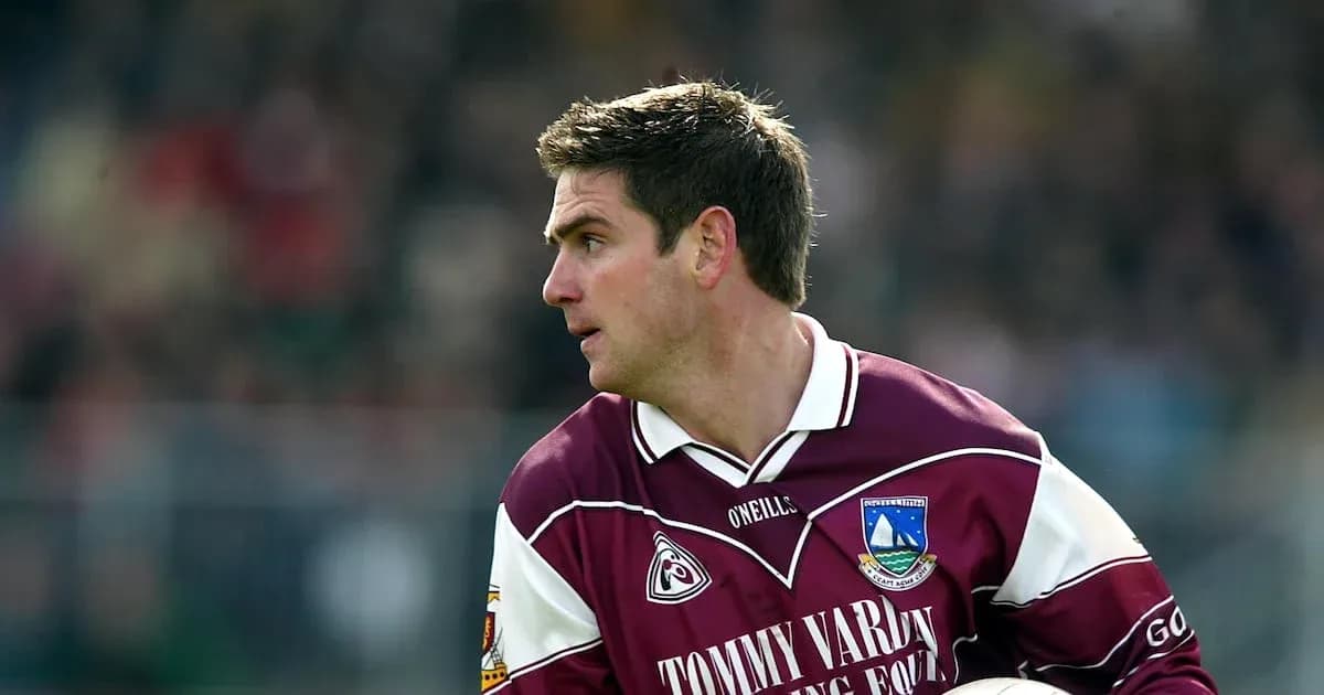 Player in maroon jersey during a match action Player in maroon jersey during a match action