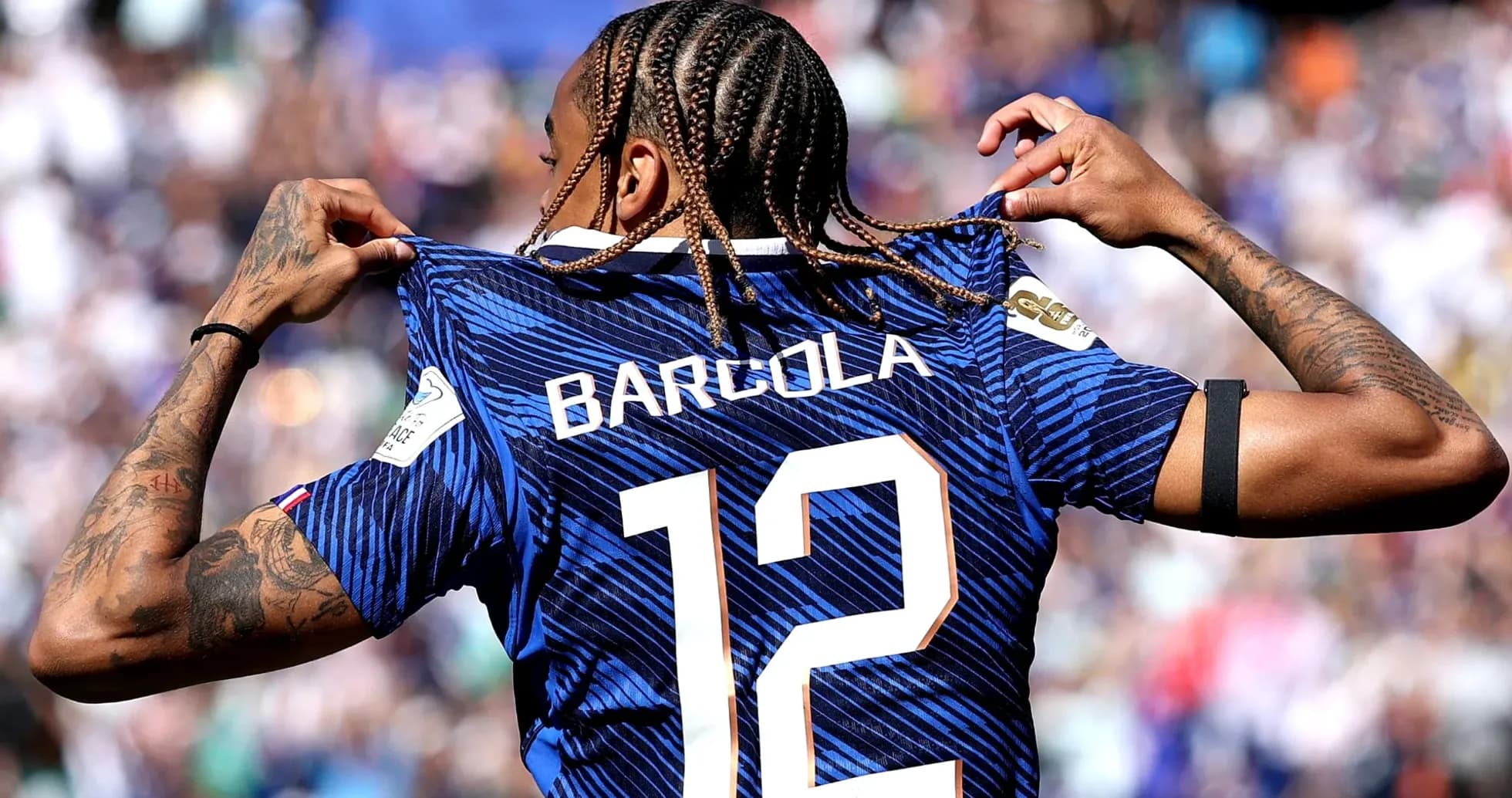 Player displaying jersey with name and number 12 Player displaying jersey with name and number 12