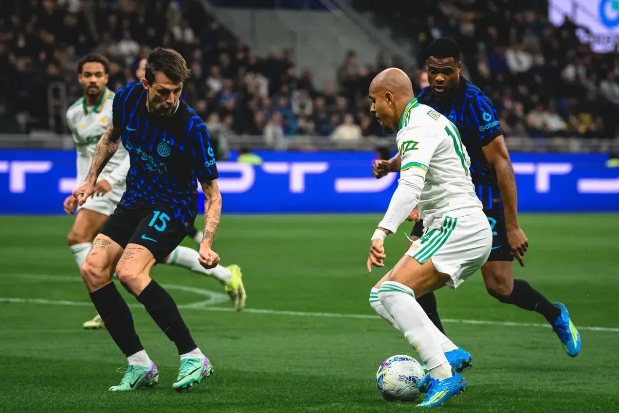 Inter player challenges AS Roma opponent for the ball Inter player challenges AS Roma opponent for the ball