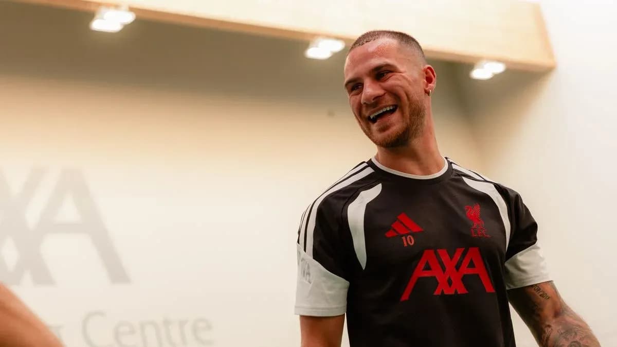Player smiling in Liverpool training kit indoors Player smiling in Liverpool training kit indoors