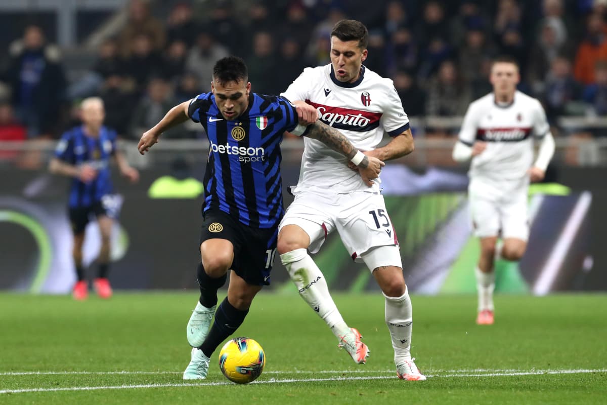 Inter player battling Bologna defender for the ball Inter player battling Bologna defender for the ball
