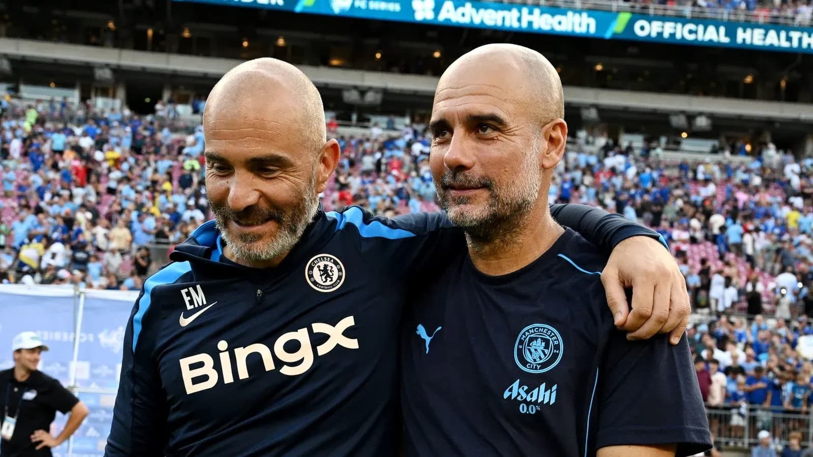 Two coaches embracing after a football match Two coaches embracing after a football match