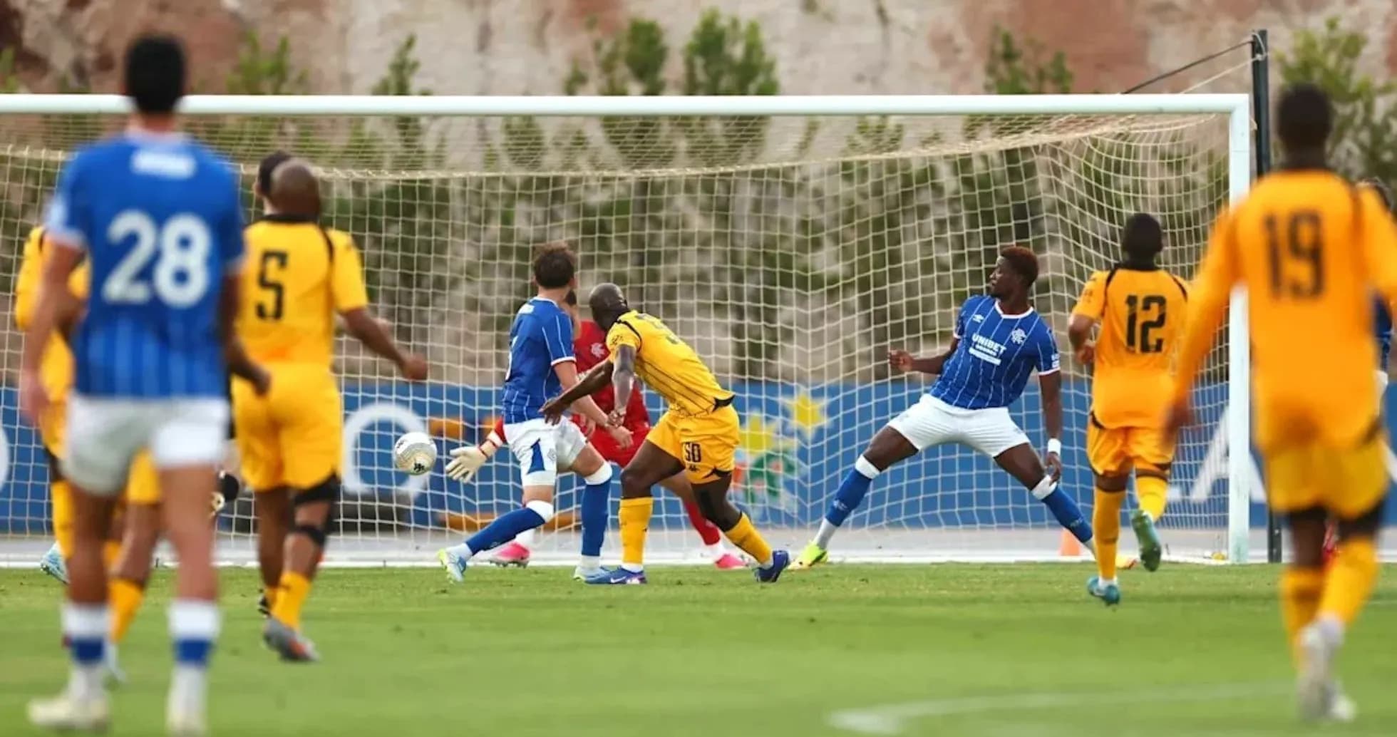 Players in action during a soccer match near goal Players in action during a soccer match near goal