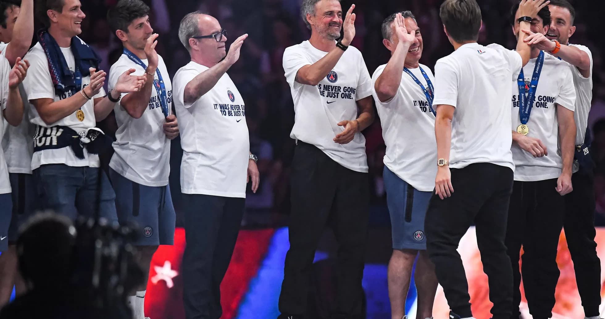 Team celebrating on stage after a victory Team celebrating on stage after a victory