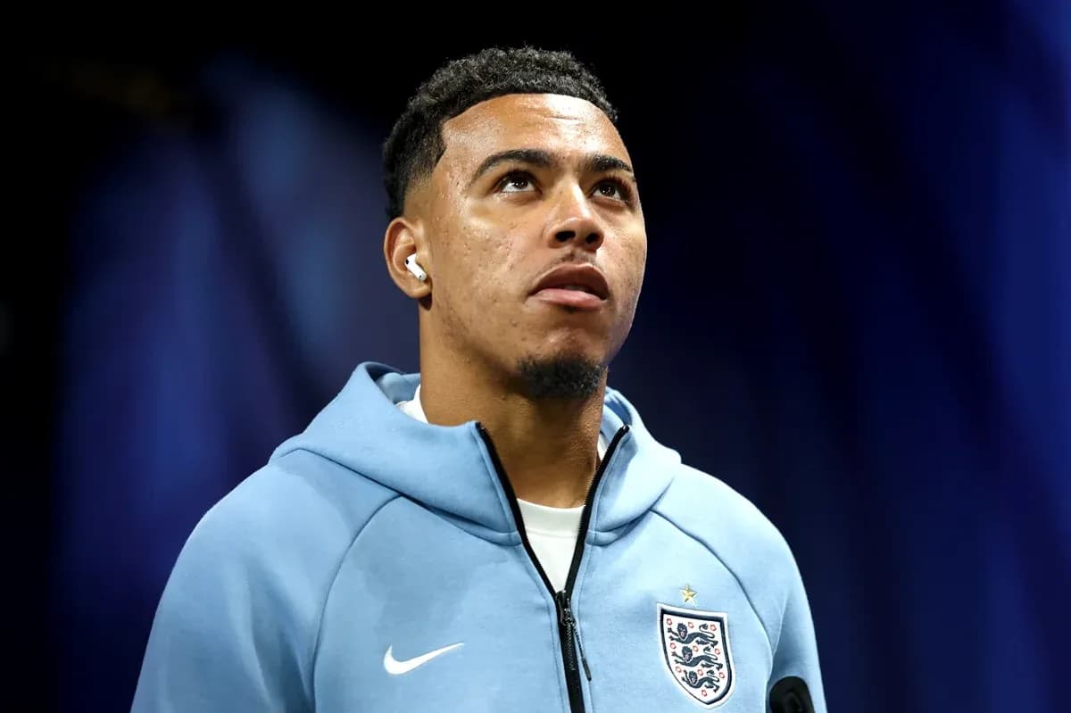 Player wearing England hoodie with earbuds, looking up Player wearing England hoodie with earbuds, looking up