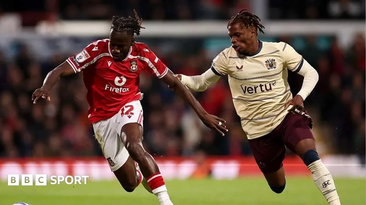 Player in red jersey dribbling past opponent in beige Player in red jersey dribbling past opponent in beige