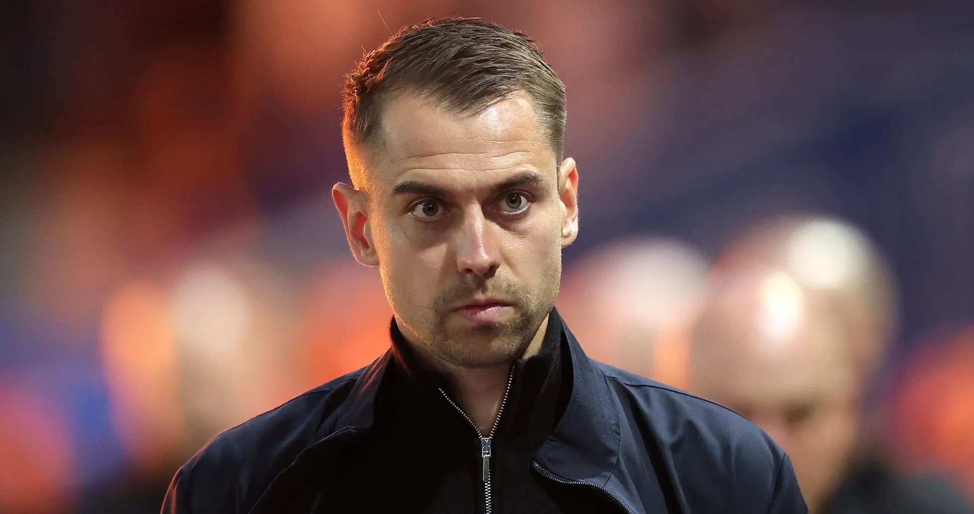 Person in dark jacket walking in stadium Person in dark jacket walking in stadium