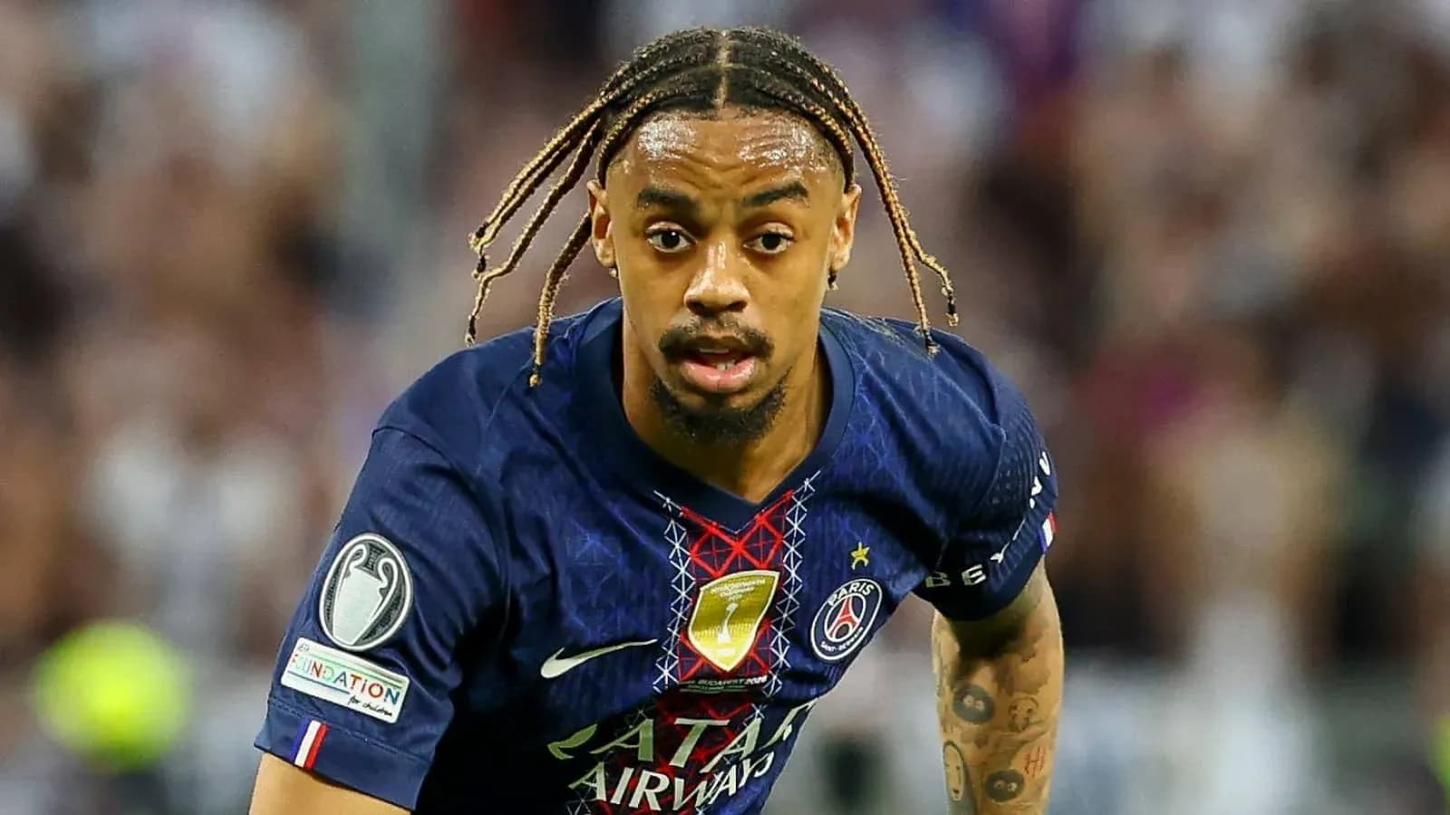 Player in Paris Saint-Germain kit running on field Player in Paris Saint-Germain kit running on field