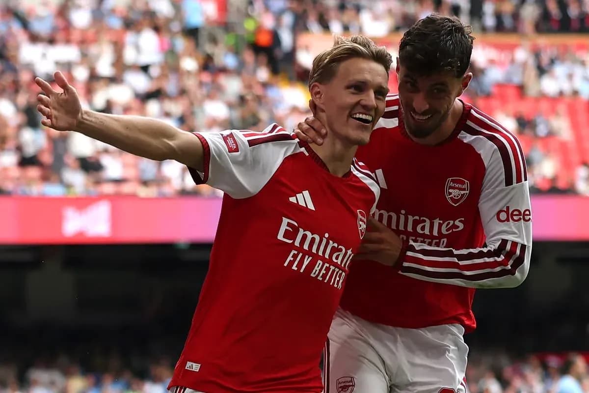 Arsenal players celebrating a goal on the pitch Arsenal players celebrating a goal on the pitch