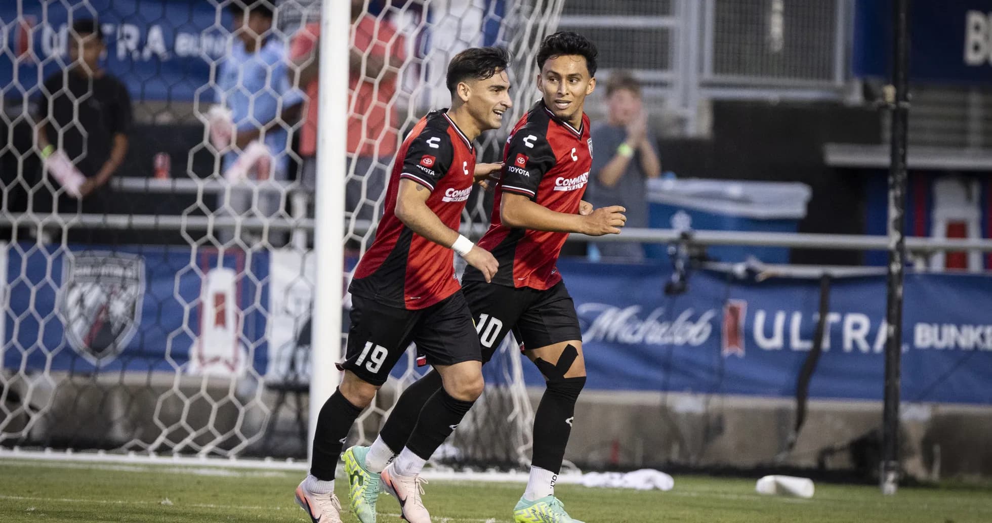 Players celebrating a goal during USL Championship match Players celebrating a goal during USL Championship match