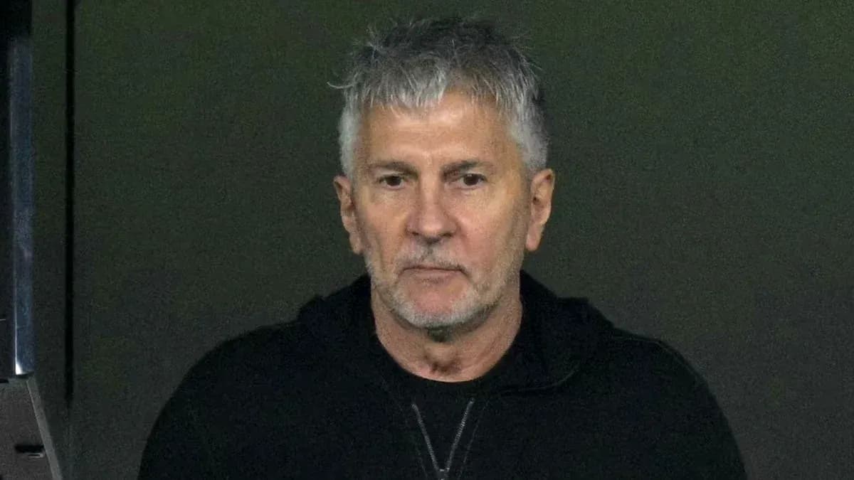 Man in black hoodie looking intently at scene Man in black hoodie looking intently at scene