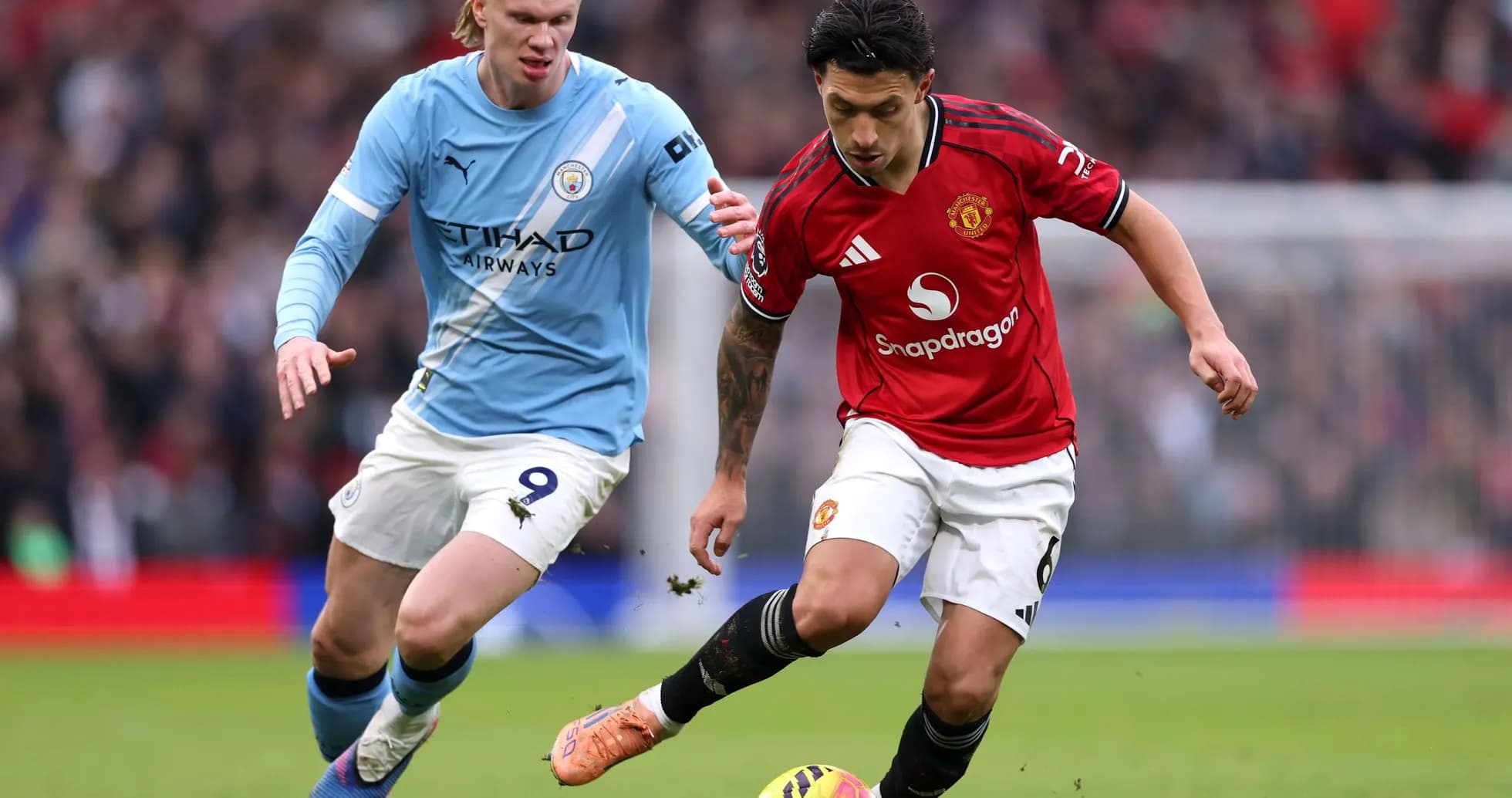 Manchester United player dribbling against Manchester City Manchester United player dribbling against Manchester City
