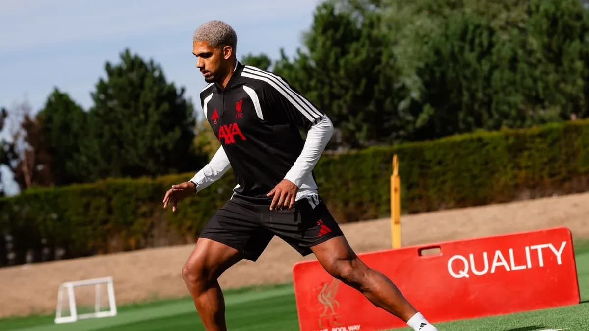Player training on the pitch wearing Liverpool gear Player training on the pitch wearing Liverpool gear