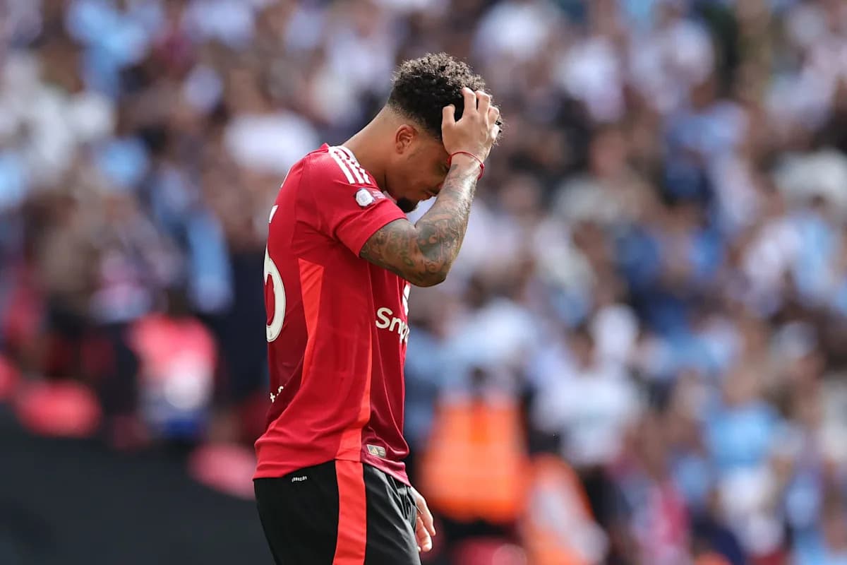 Player in red jersey holding head in disappointment Player in red jersey holding head in disappointment