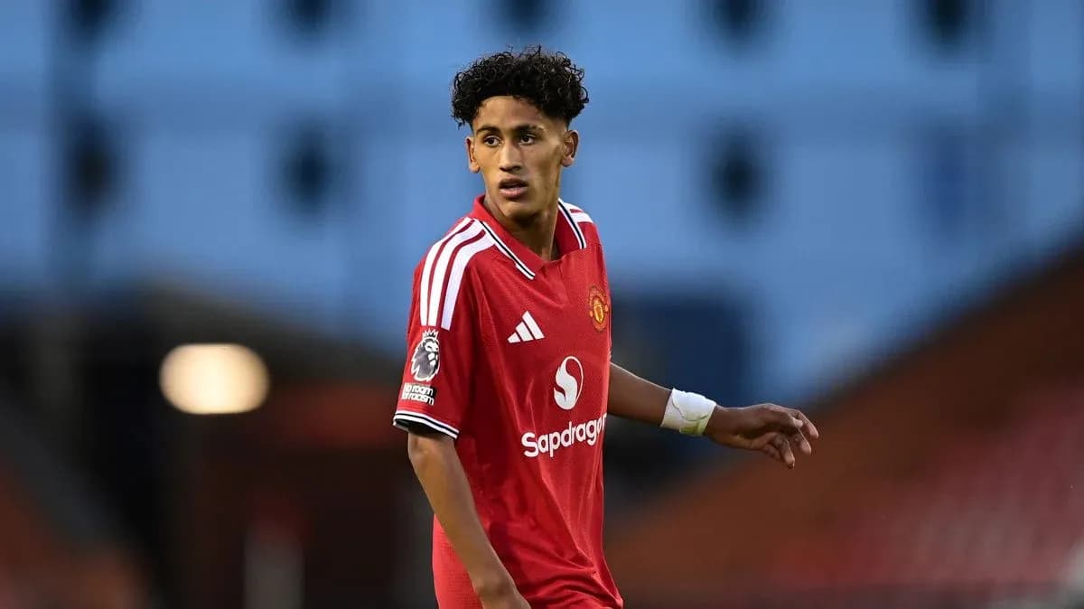 Young player wearing Manchester United jersey on field Young player wearing Manchester United jersey on field