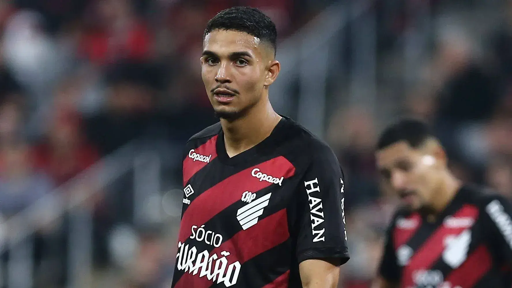 Player in red and black jersey during match Player in red and black jersey during match