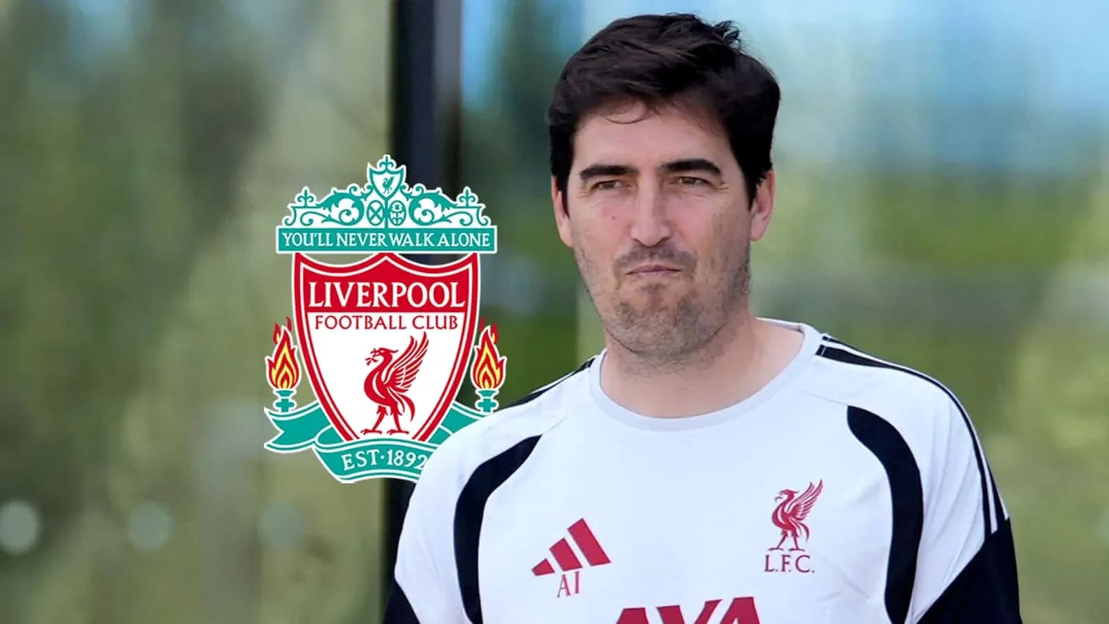 Coach walking in Liverpool FC training gear Coach walking in Liverpool FC training gear