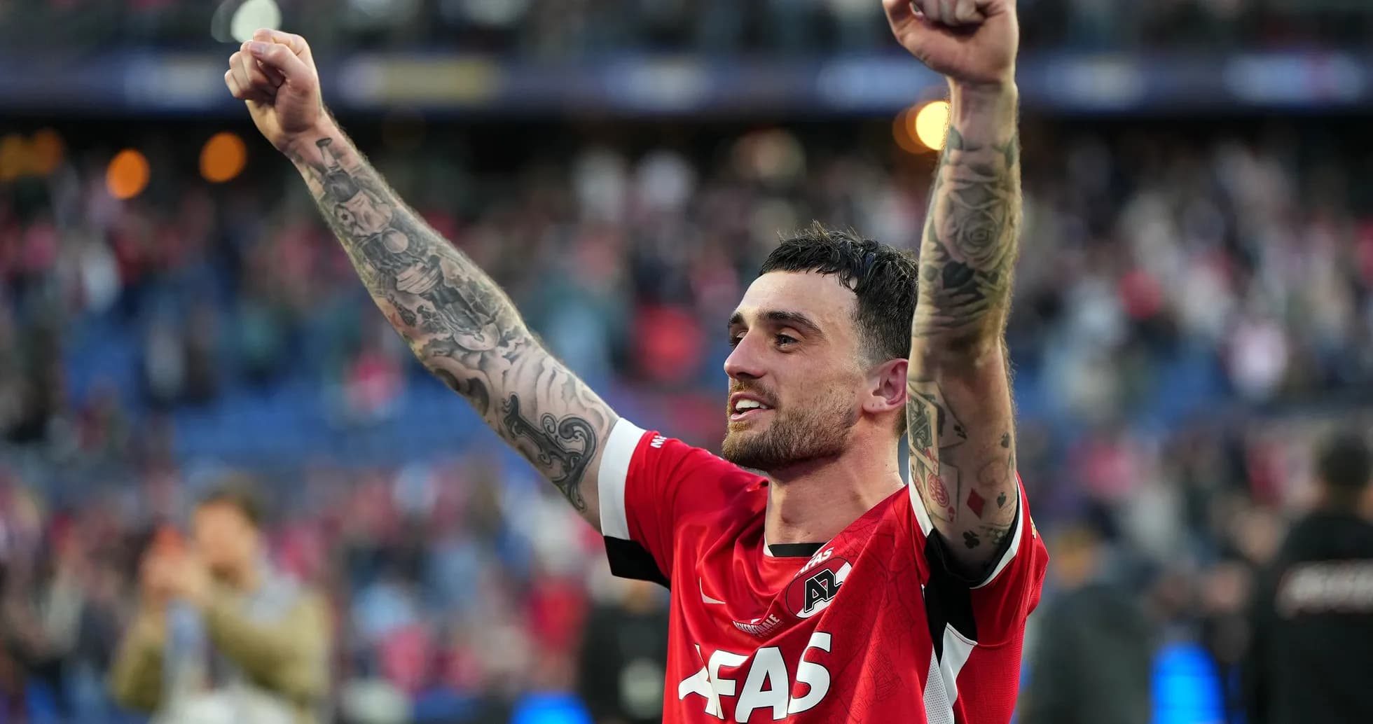 Player celebrating with raised arms after match Player celebrating with raised arms after match