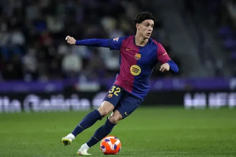 Player in Barcelona kit dribbling the ball on field Player in Barcelona kit dribbling the ball on field