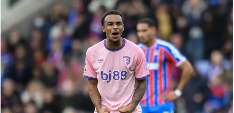 Player celebrating in pink kit during match Player celebrating in pink kit during match