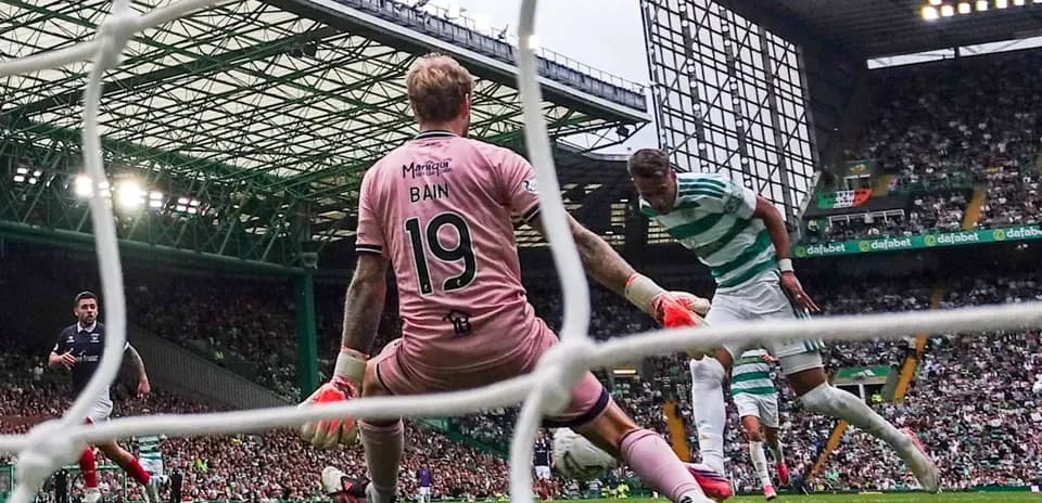 Goalkeeper Bain attempting to save a shot on goal Goalkeeper Bain attempting to save a shot on goal