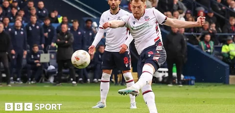Bolton player taking a shot during a match Bolton player taking a shot during a match