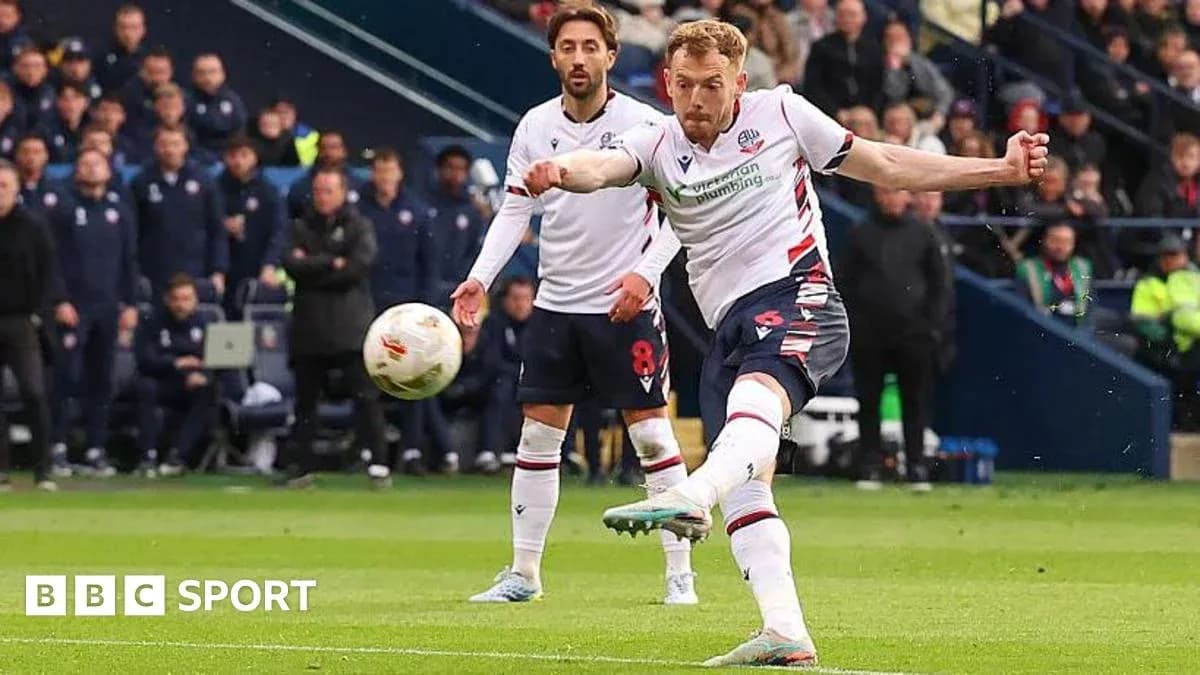 Bolton player taking a shot during a match Bolton player taking a shot during a match