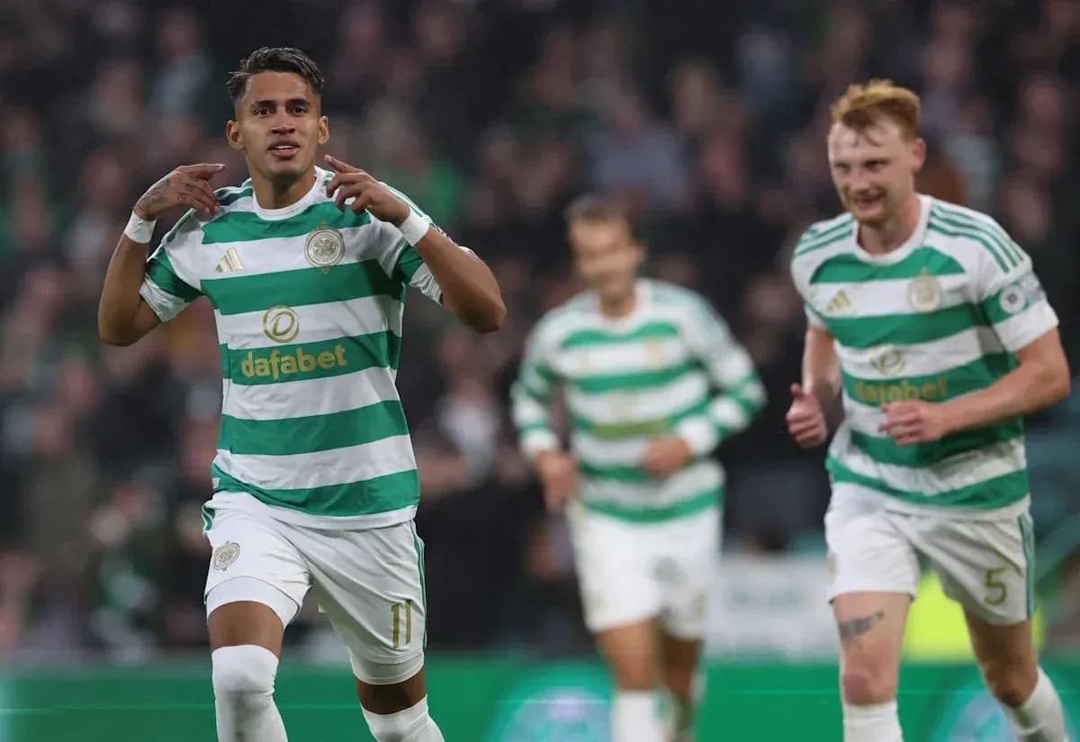 Celtic players celebrating a goal on the pitch Celtic players celebrating a goal on the pitch
