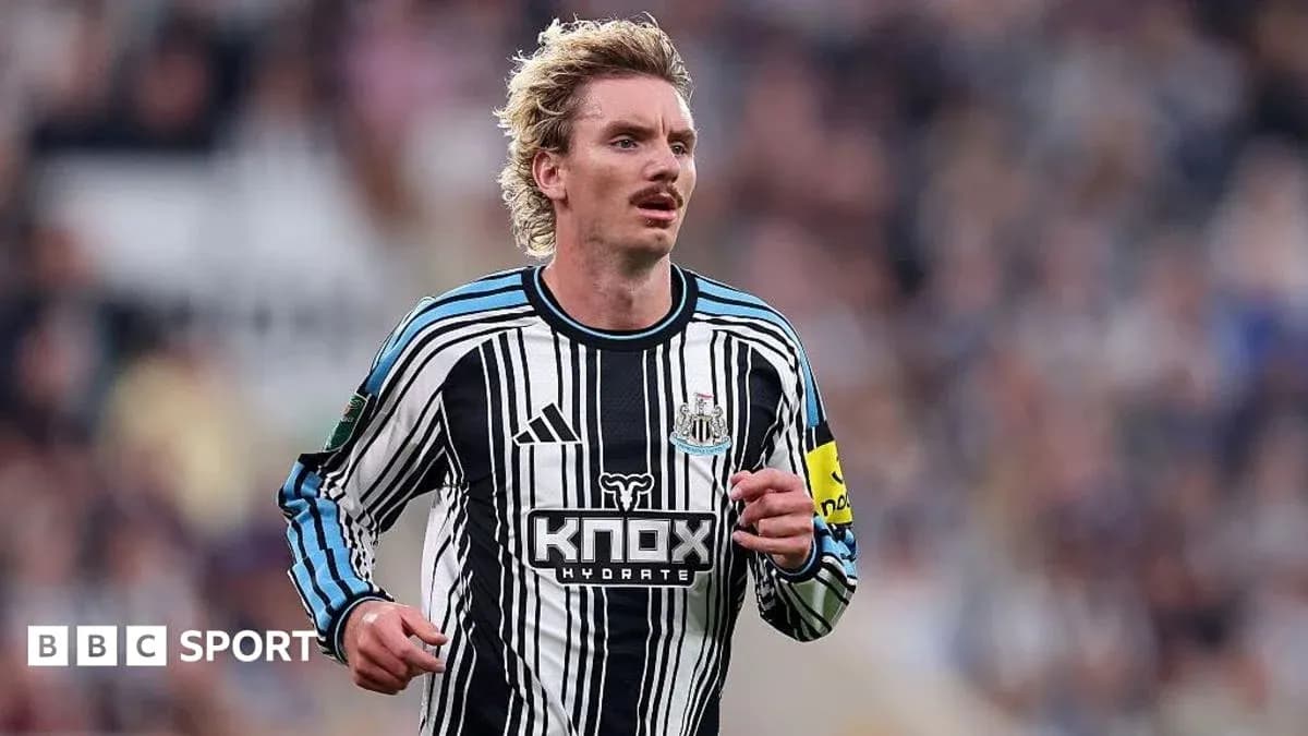 Player running in Newcastle United striped jersey Player running in Newcastle United striped jersey