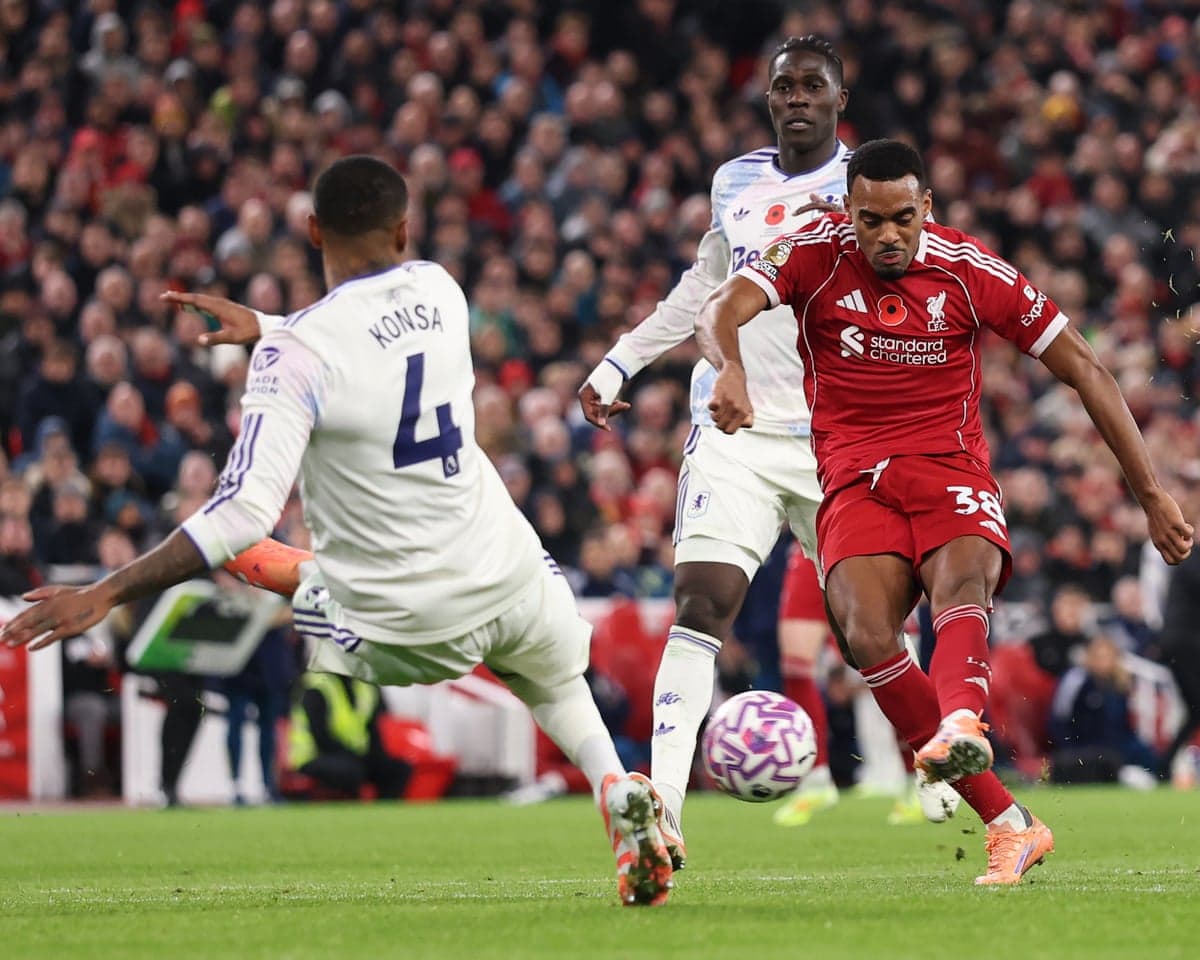 Aston Villa player challenges Liverpool forward during match Aston Villa player challenges Liverpool forward during match