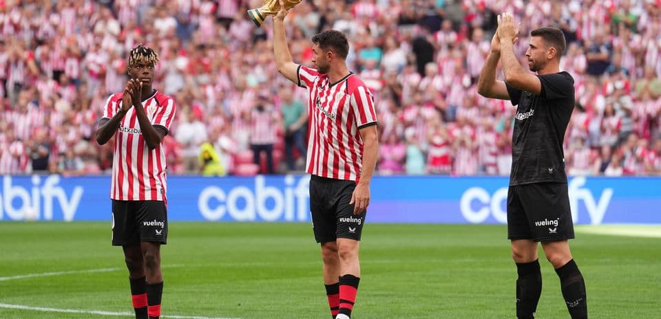 Players celebrating with a trophy in stadium Players celebrating with a trophy in stadium