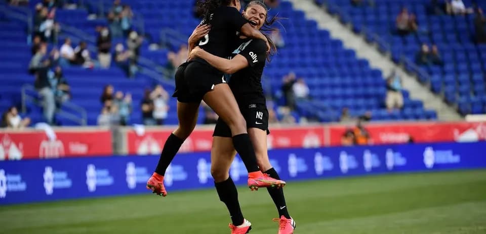 Players celebrating a goal during NWSL match Players celebrating a goal during NWSL match