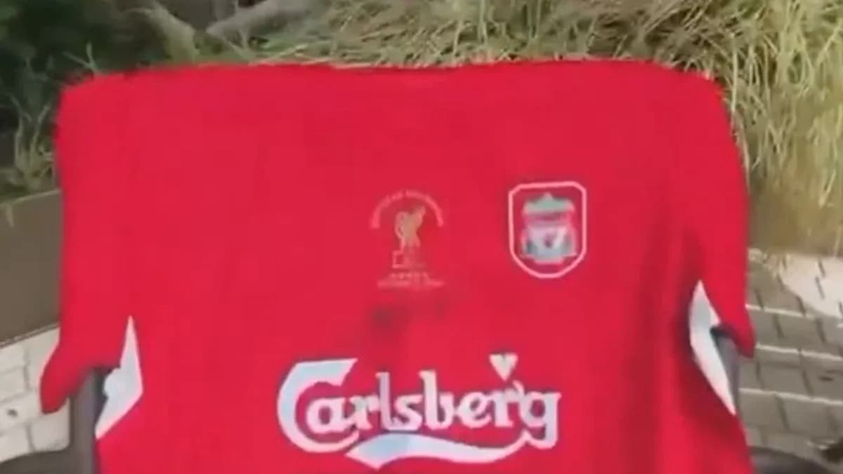 Red Liverpool jersey with Carlsberg logo displayed outdoors Red Liverpool jersey with Carlsberg logo displayed outdoors