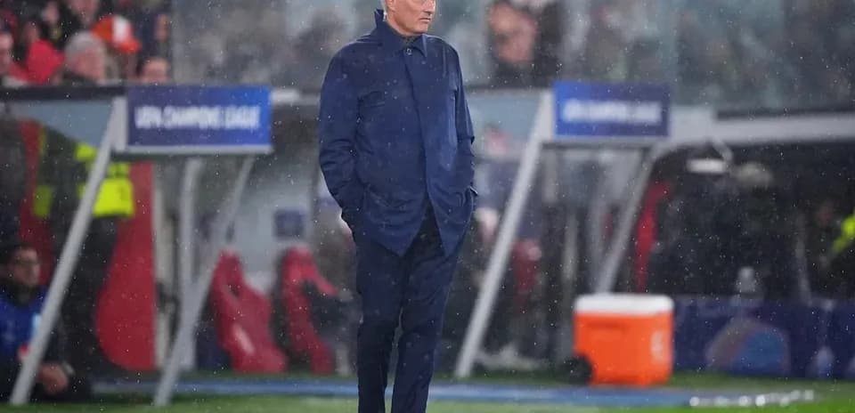 Coach observing match in rainy conditions on sideline Coach observing match in rainy conditions on sideline