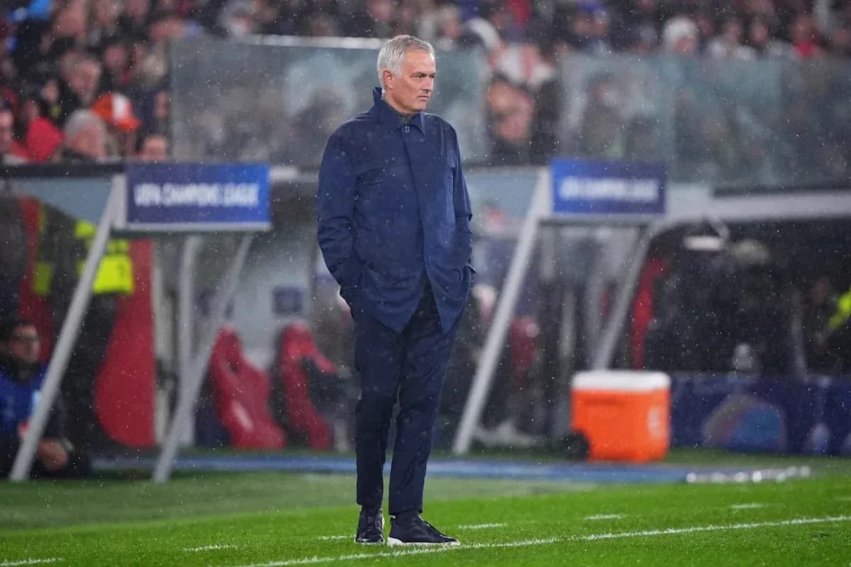 Coach observing match in rainy conditions on sideline Coach observing match in rainy conditions on sideline