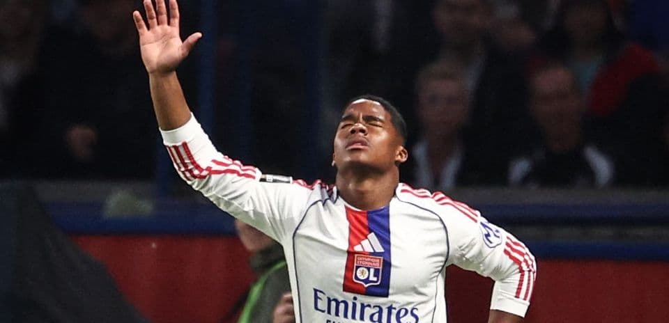 Player celebrating a goal with arms raised Player celebrating a goal with arms raised