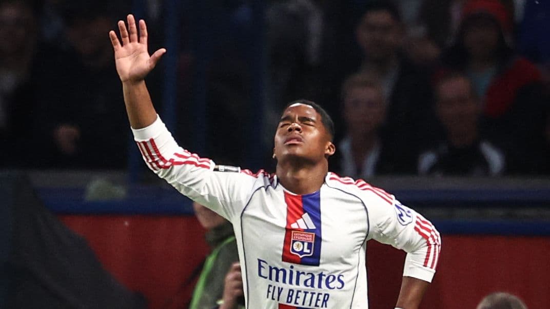 Player celebrating a goal with arms raised Player celebrating a goal with arms raised