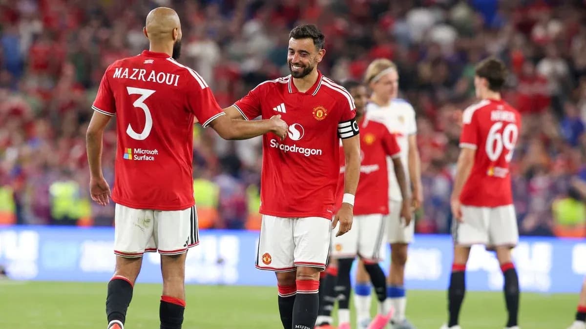 Bruno Fernandes and Mazraoui celebrating on the pitch Bruno Fernandes and Mazraoui celebrating on the pitch