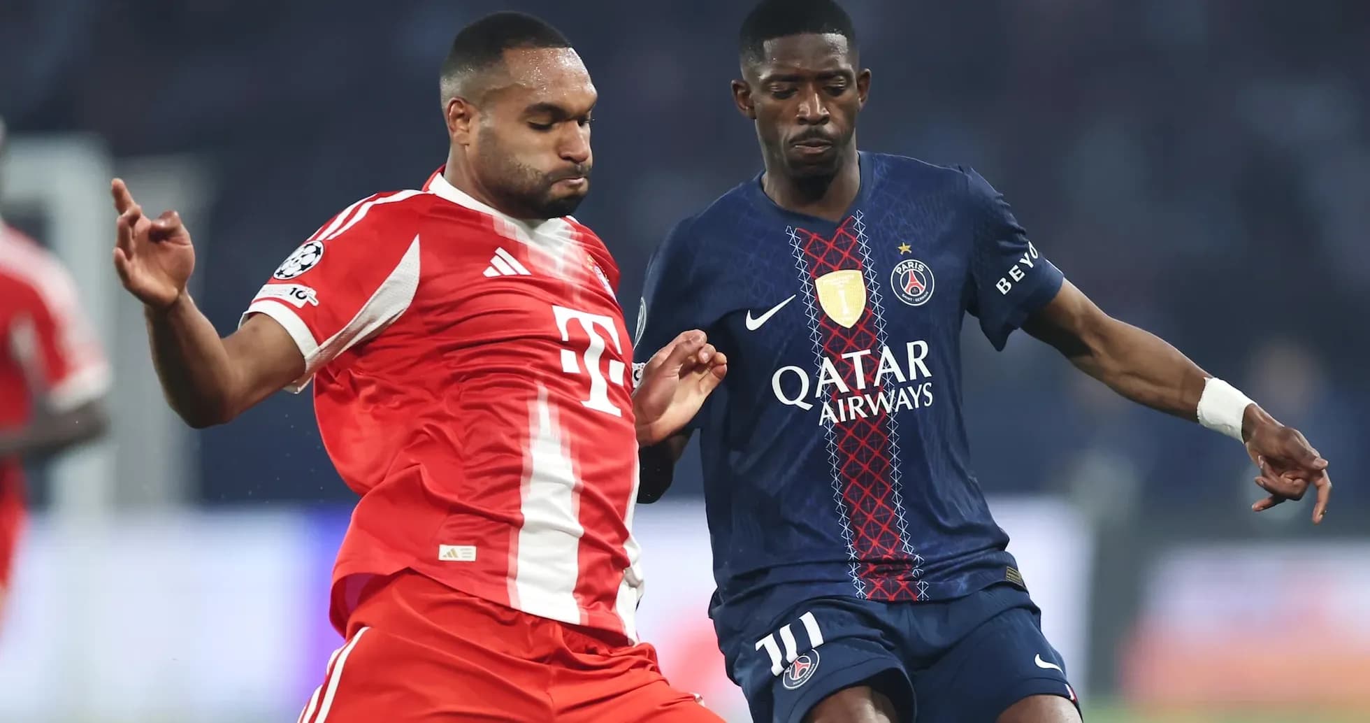 Bayern player challenging Paris player for the ball Bayern player challenging Paris player for the ball