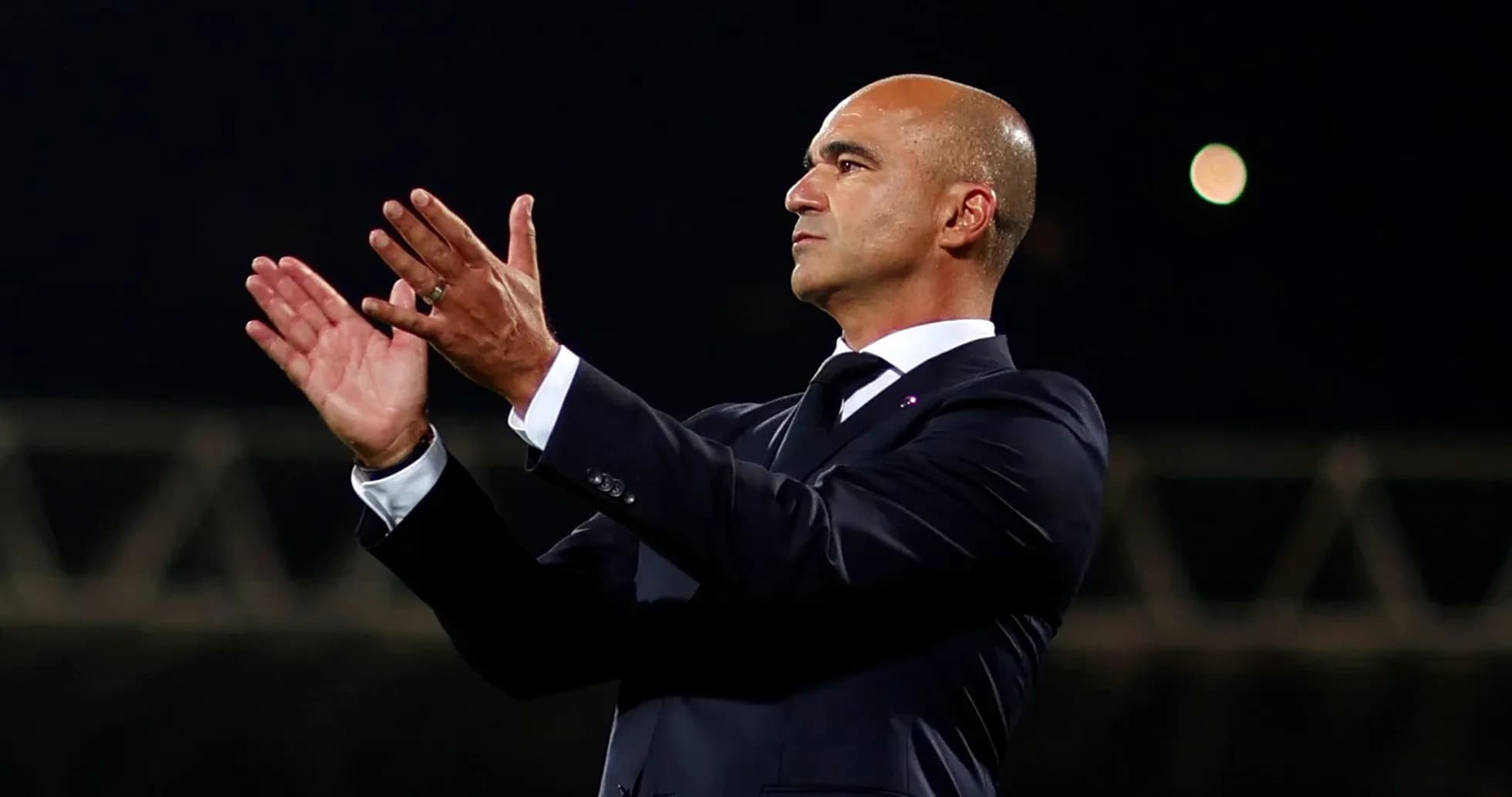 Manager applauding during a match on the sidelines Manager applauding during a match on the sidelines
