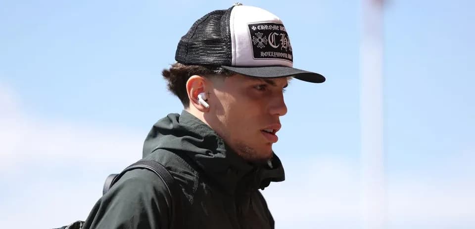 Player wearing a cap and earbuds walking outdoors Player wearing a cap and earbuds walking outdoors